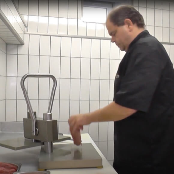 Person drückt Fleisch in die mitte
